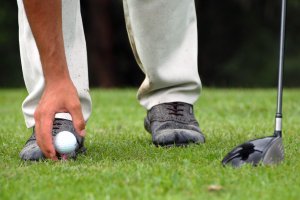 Placing Golf Ball On Tee